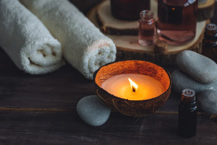 Spa candles, towels on dark background